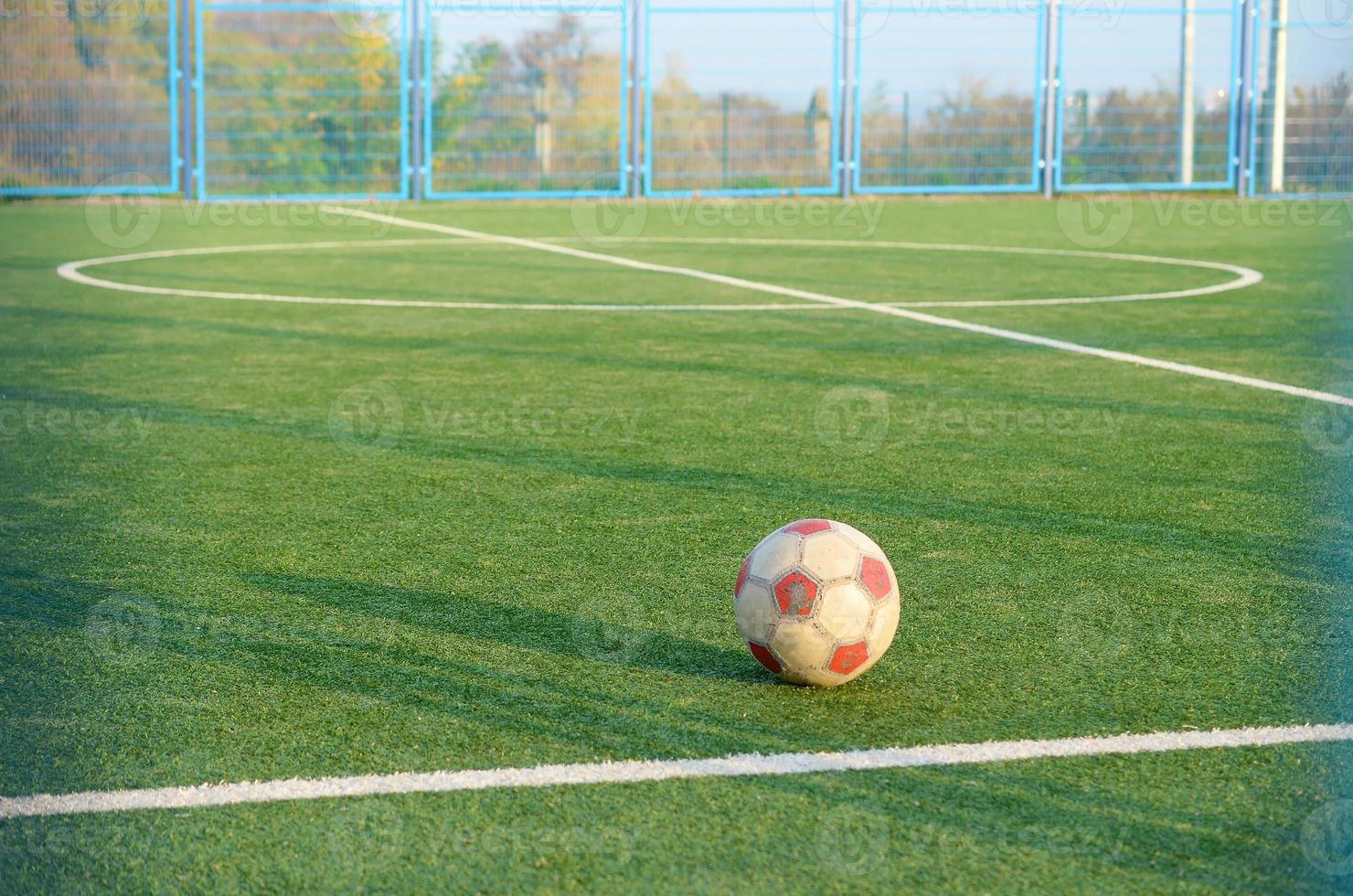 Classic soccer ball on football green grass field outdoor. Active sports and physical training photo