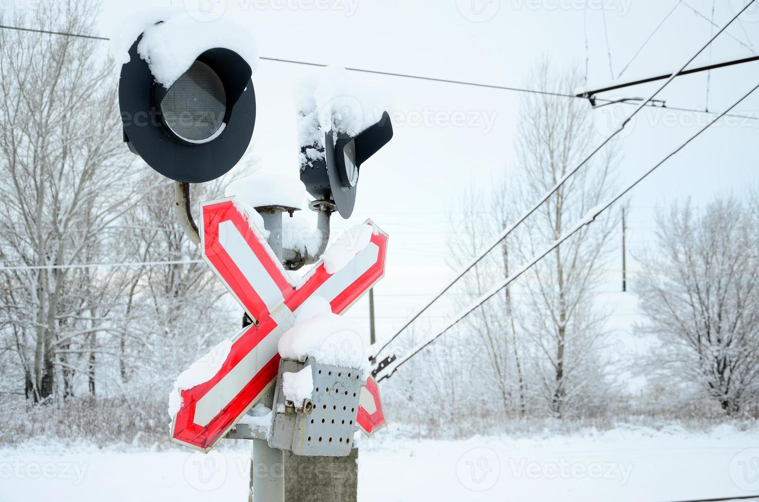 Semaphore is located on the motorway crossing the railway line in winter season photo