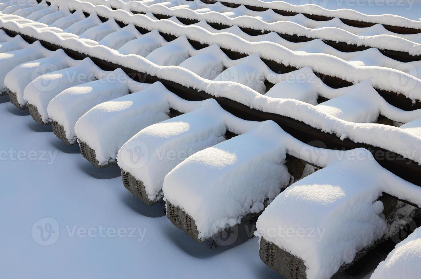 A lot of old rails and sleepers are stacked in a railway warehouse in winter. The concept of renewing a worn-out railway track photo