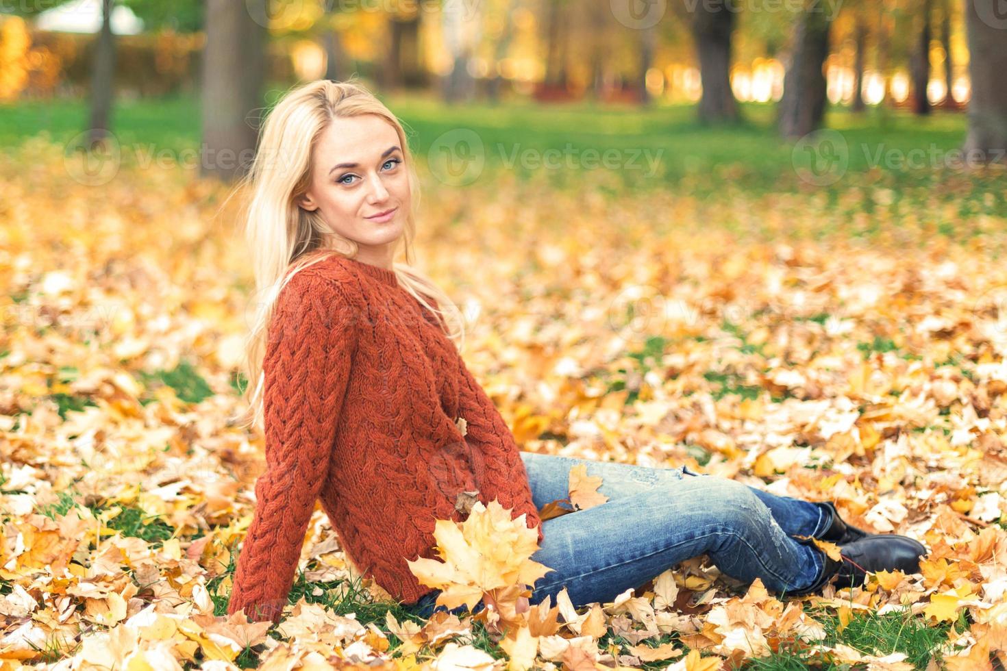 Young woman in park on autumn day photo