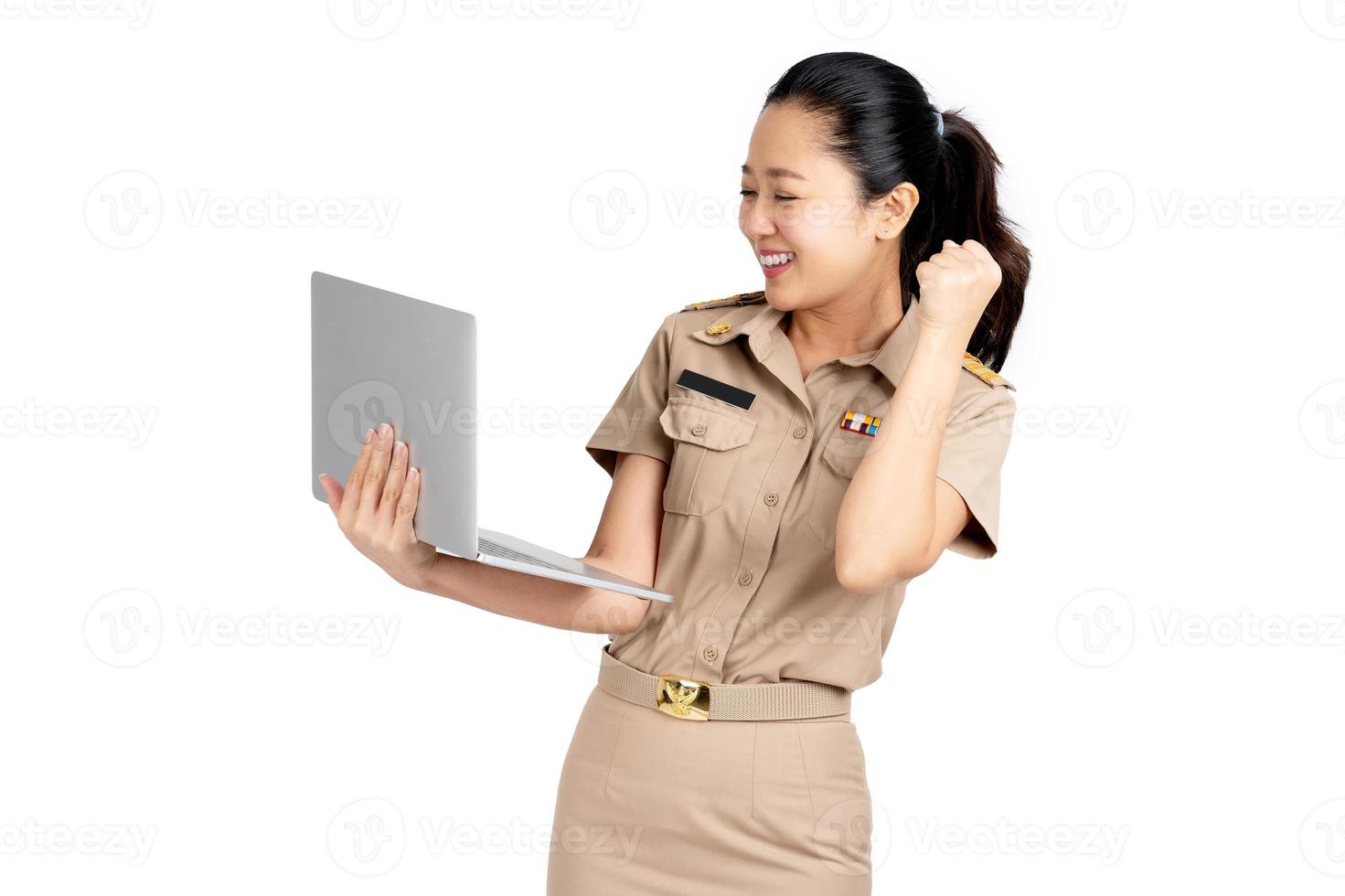 Beautiful Asian female teacher hands up raised arms from happiness and holding laptop computer isolated on white background, Excited woman winner success concept. photo