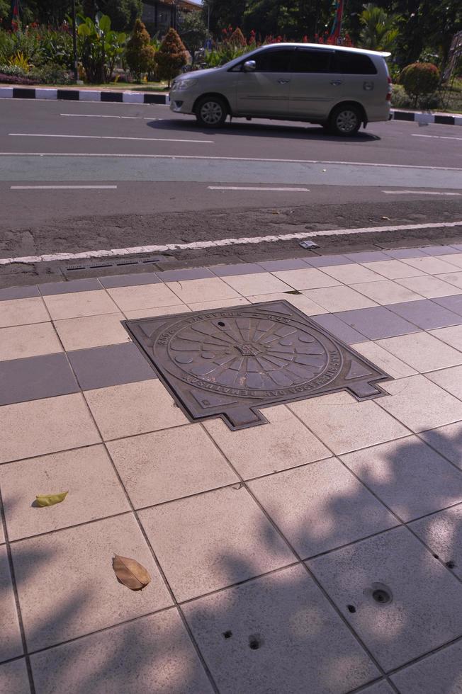 surabaya, june 2022 - cover the sewer wells on the sidewalks of surabaya city photo