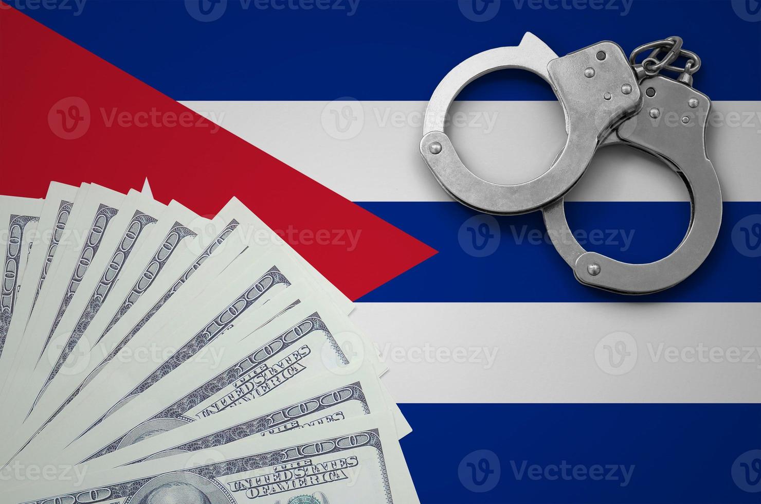 Cuba flag  with handcuffs and a bundle of dollars. The concept of illegal banking operations in US currency photo