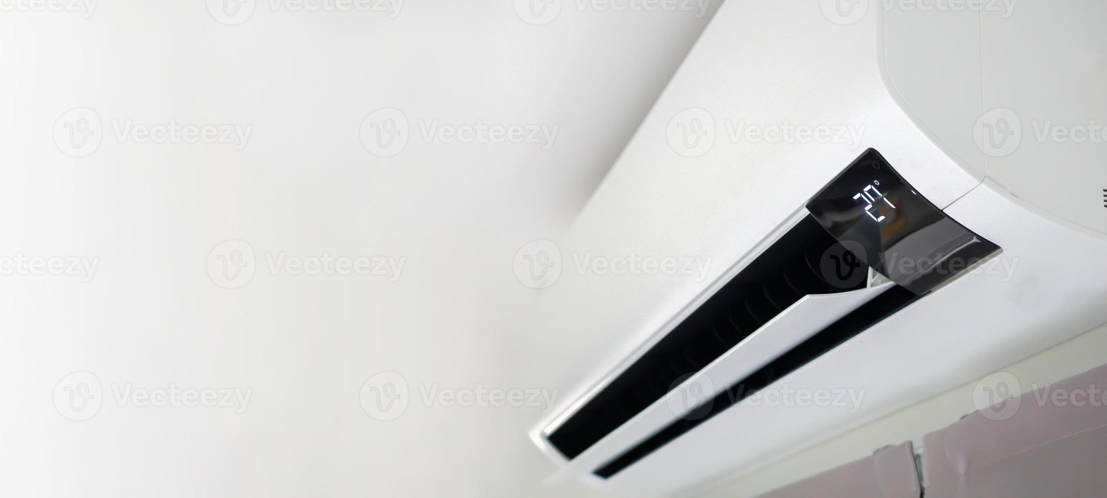 Air conditioner on white wall room interior background photo