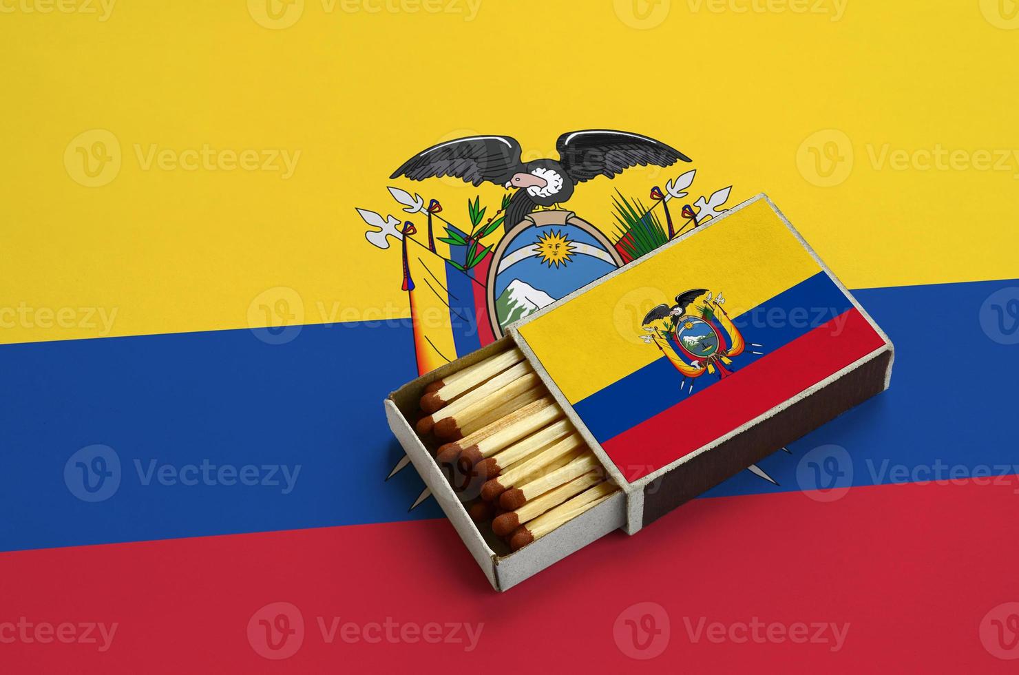 Ecuador flag  is shown in an open matchbox, which is filled with matches and lies on a large flag photo