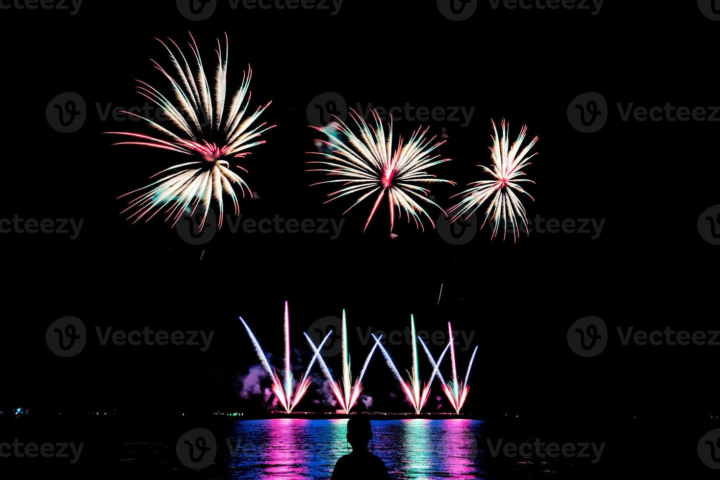 fireworks celebration over sea in pattaya beach photo