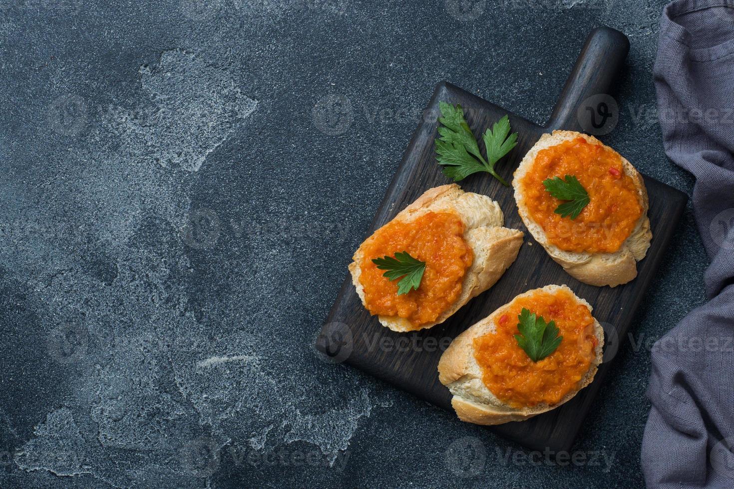 Sandwiches with bread zucchini caviar tomatoes onions. Homemade vegetarian food. Copy space. photo