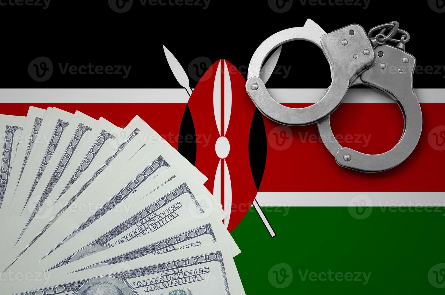 Kenya flag  with handcuffs and a bundle of dollars. The concept of illegal banking operations in US currency photo