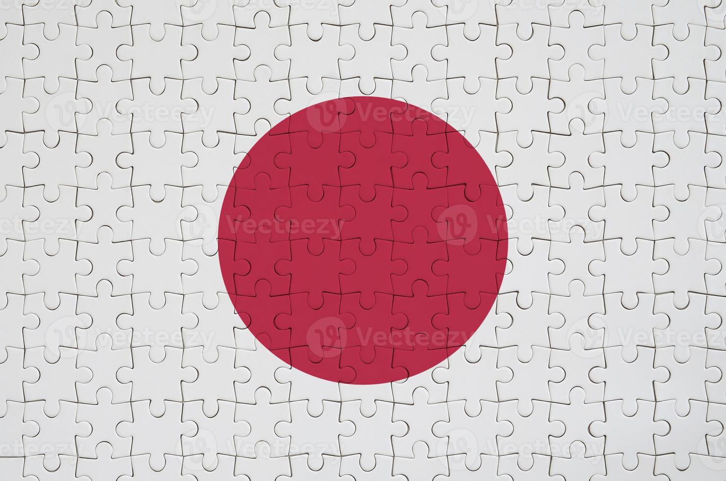 Japan flag  is depicted on a folded puzzle photo