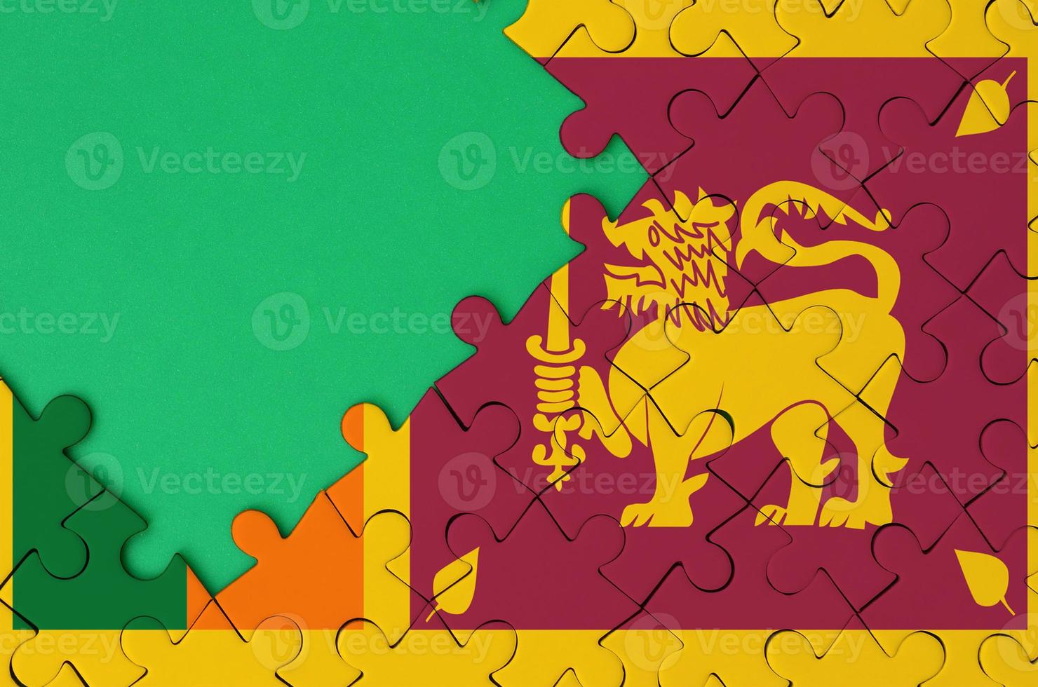 Sri Lanka flag  is depicted on a completed jigsaw puzzle with free green copy space on the left side photo