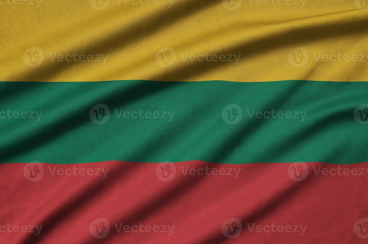 Lithuania flag  is depicted on a sports cloth fabric with many folds. Sport team banner photo