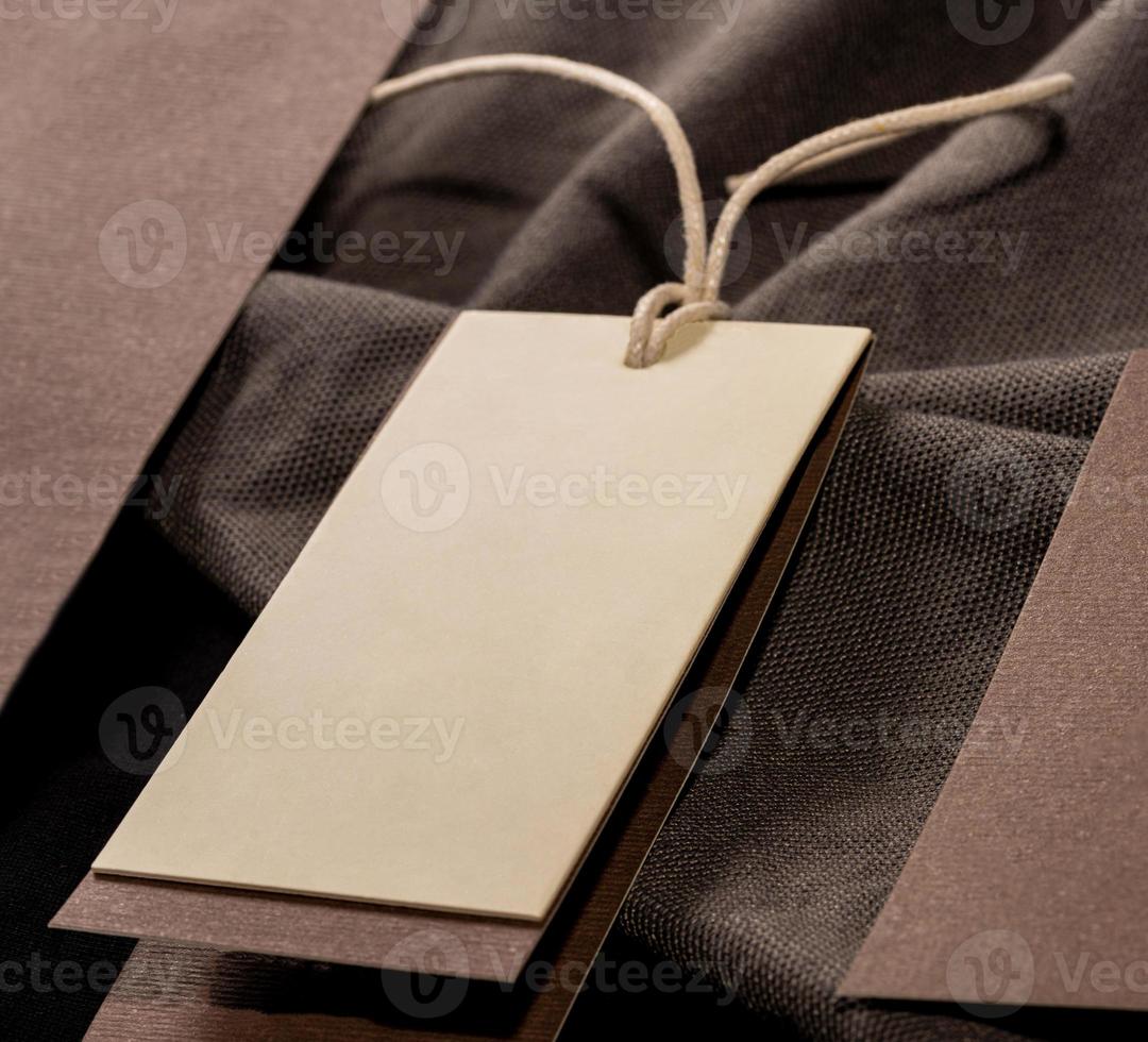 A closeup shot of a blank clothing tag on a string for a price label on a cloth photo