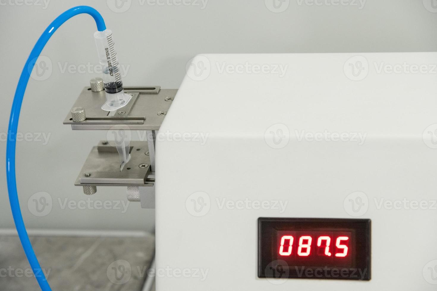A closeup of the production and testing of medical syringes and droppers photo