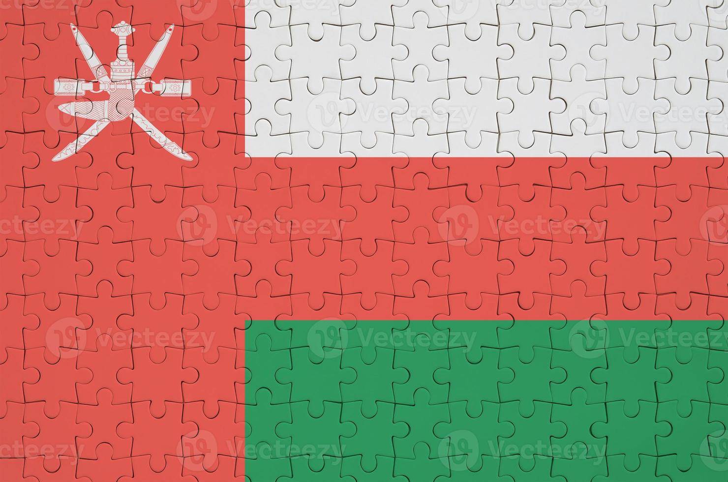 Oman flag  is depicted on a folded puzzle photo