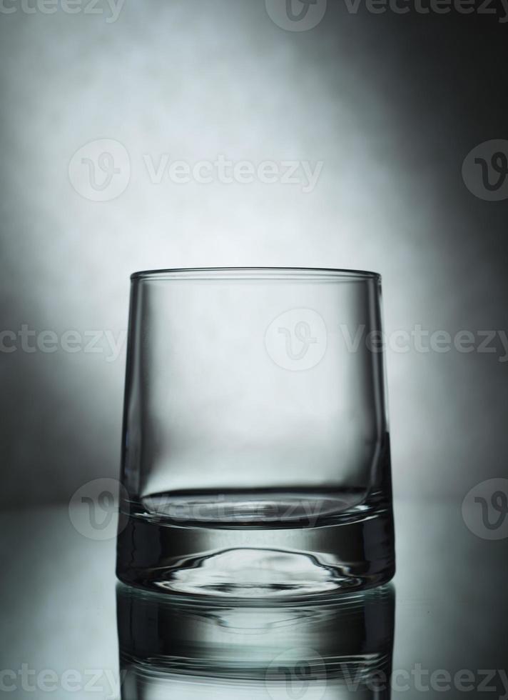 A vertical shot of an empty glass on a grey background photo