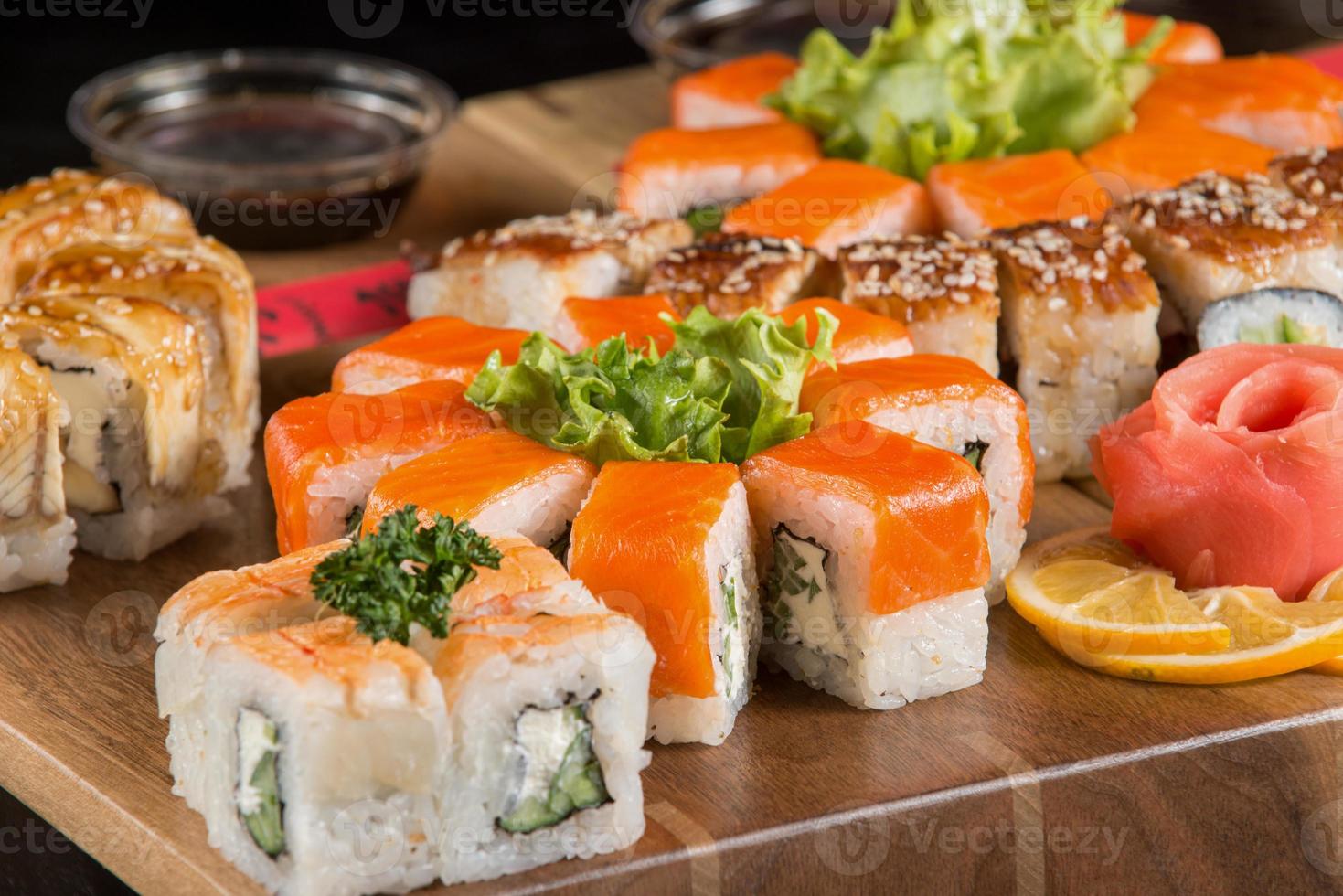 A closeup shot of a sushi set on a wooden plate photo