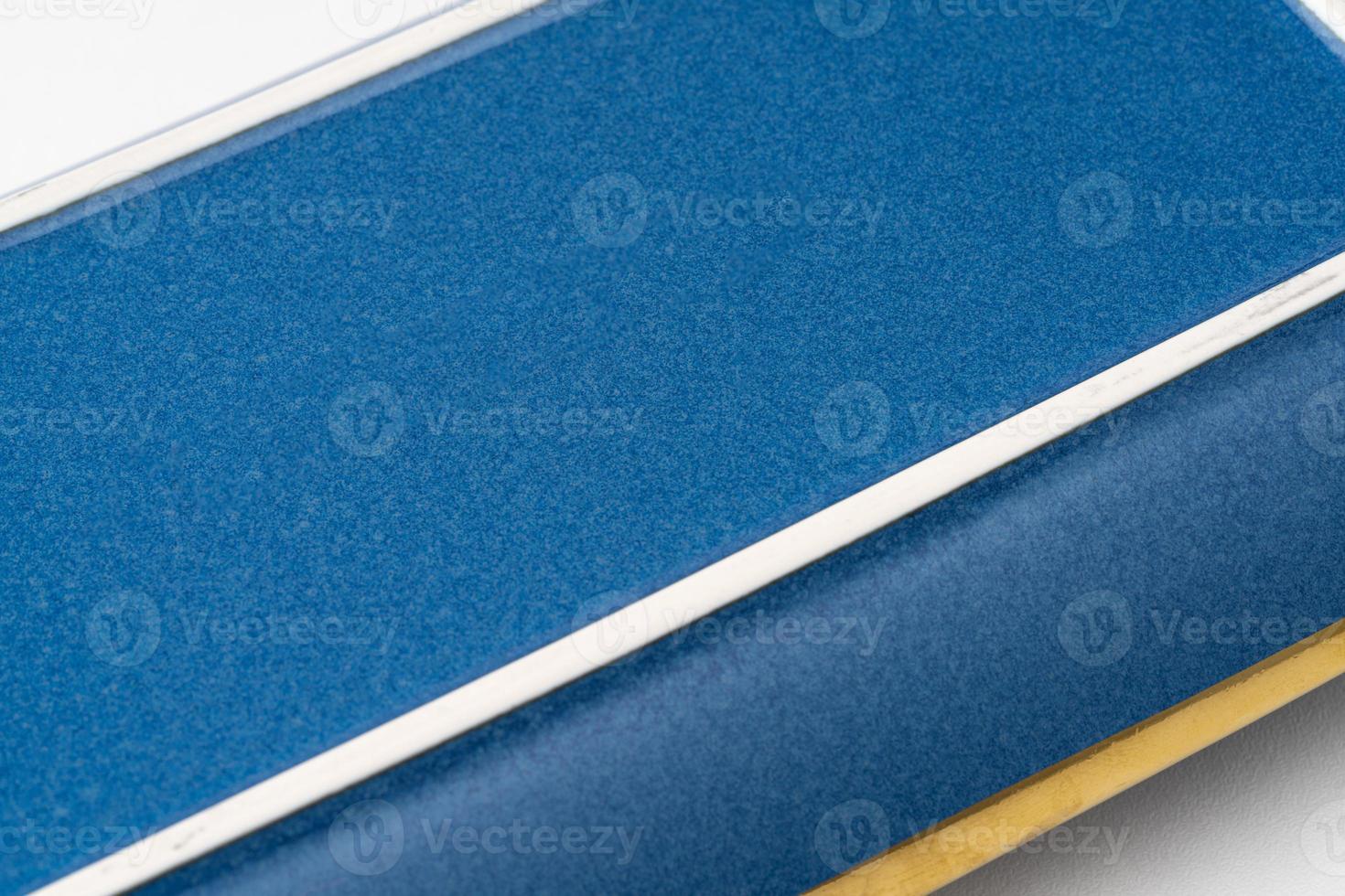 A closeup shot of the underside of a blue rectangular plate photo