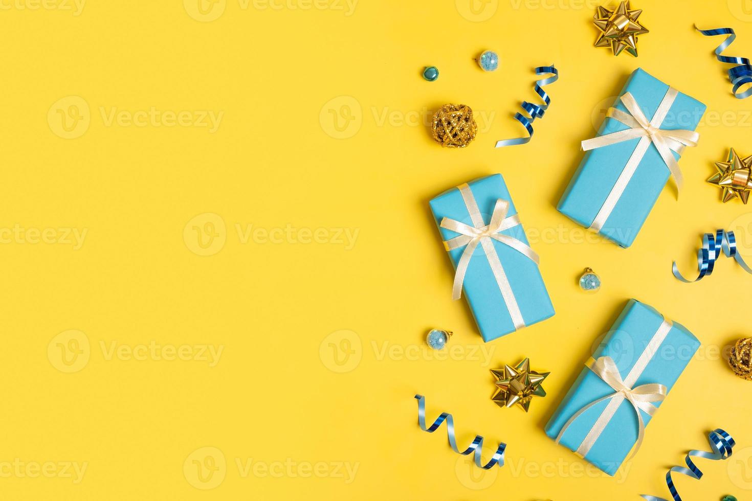 Christmas festive composition with gift boxes and decorations on colored background top view, flat lay. Copy space photo