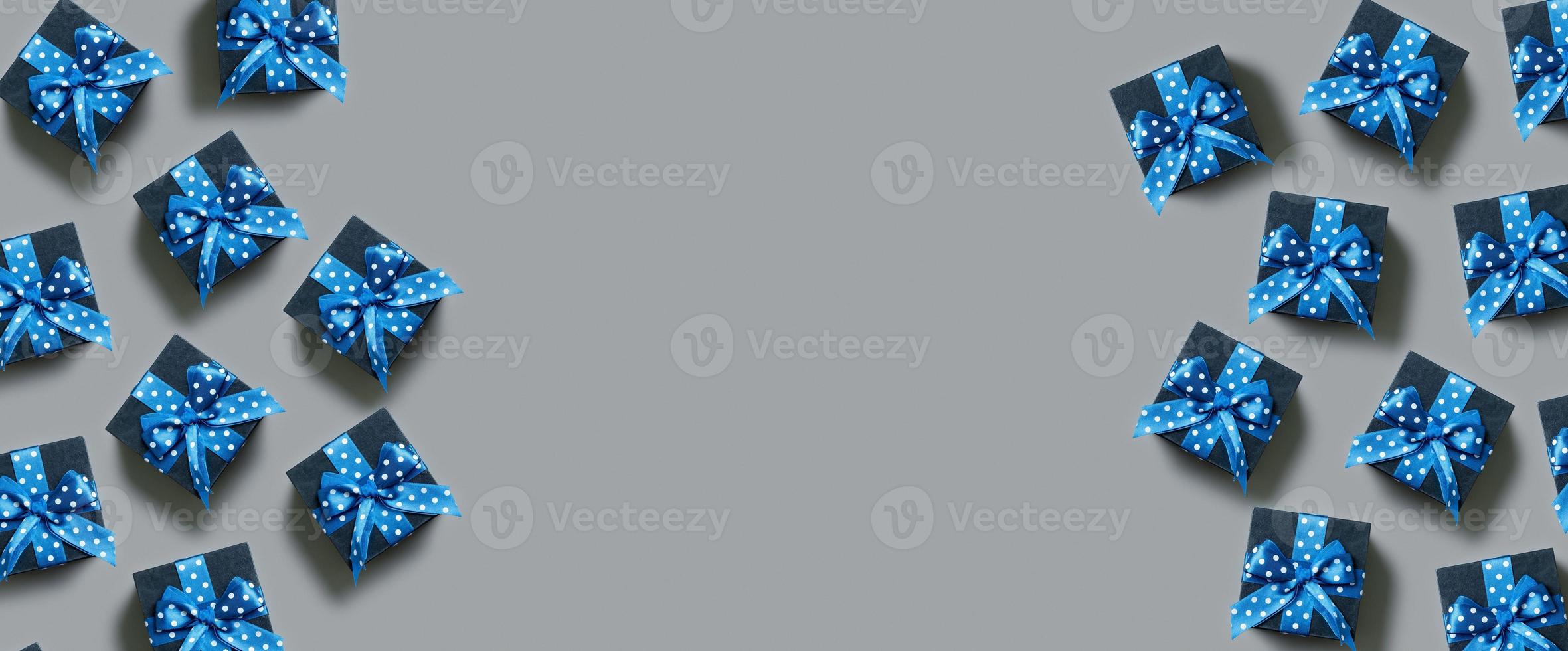 Banner with Black gift boxes with bow flat lay on grey background. View from above. Copy space photo