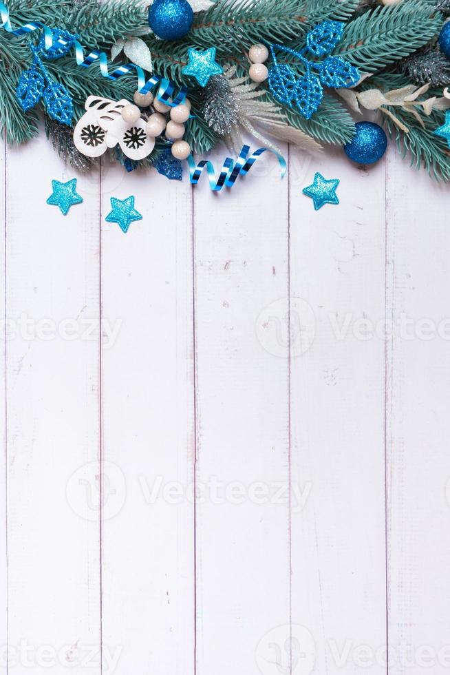 Christmas vertical background made from pine tree, berries and festive decorations top view. Christmas flat lay photo