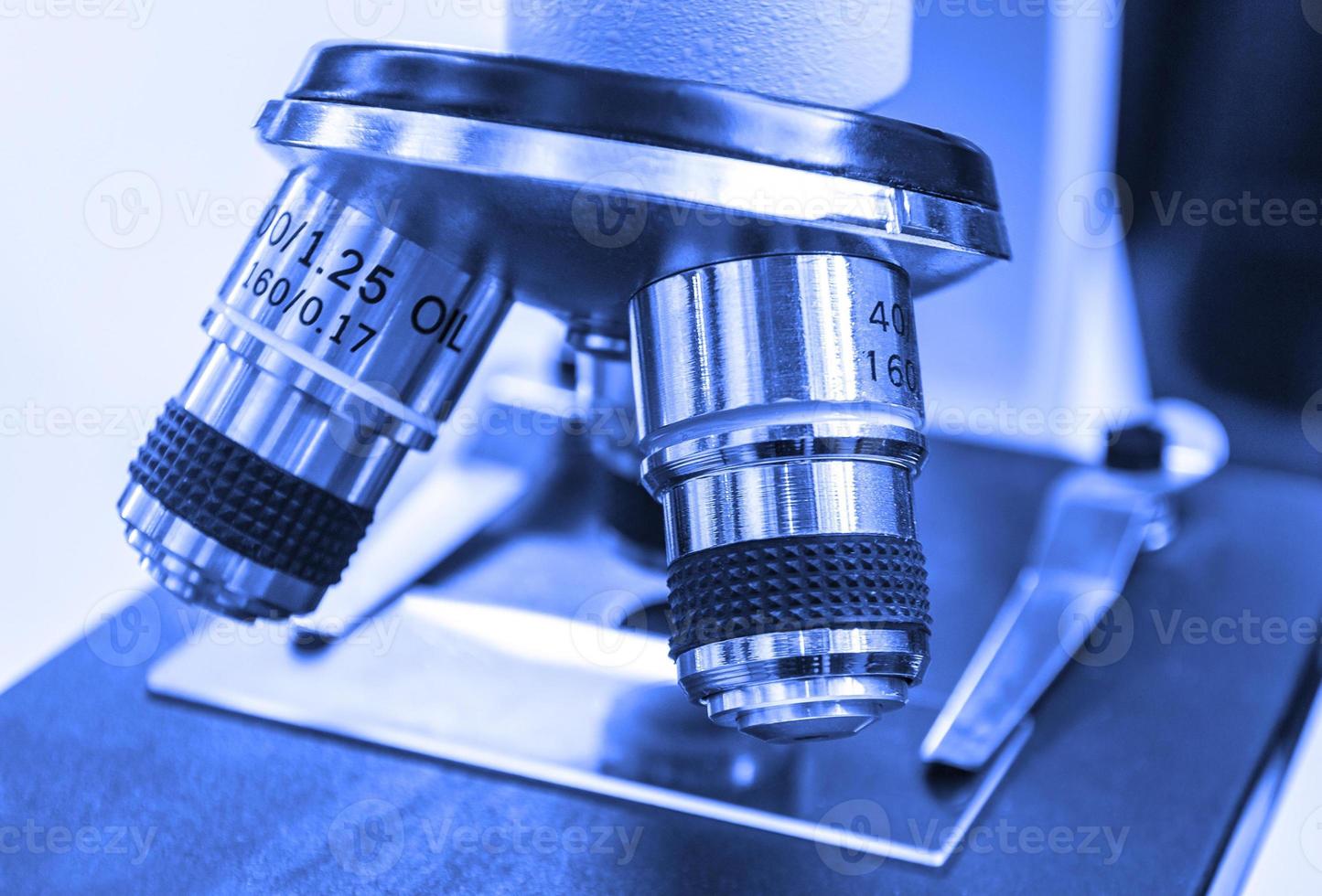 Closeup lens of a modern microscope in a research lab. Selective focus photo