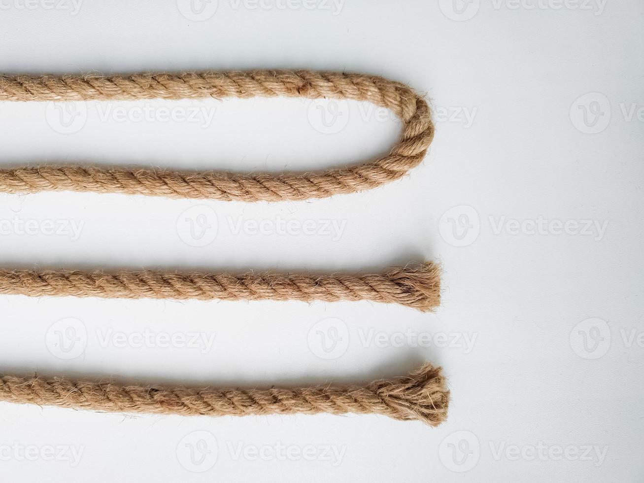 Rough natural rope strings on white background photo