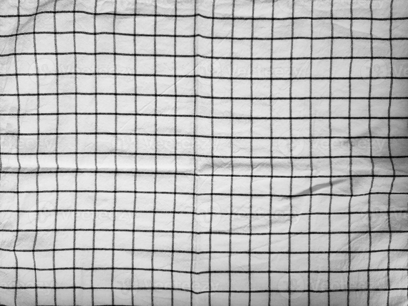 Checkered tablecloth fabric or towel. Black with white square pattern photo