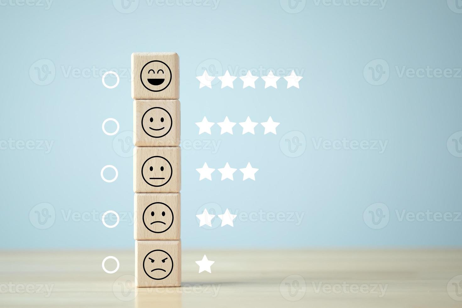 Business or customer service rating experience and feedback emotion and satisfaction and mental health survey concept. Wood cube with star and negative, neutral and positive facial expressions. photo