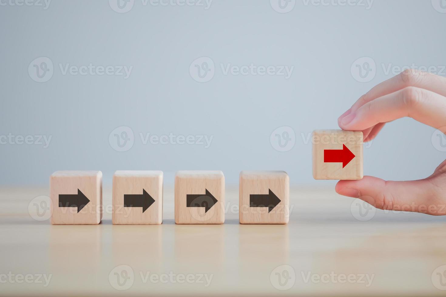 Hand holding red arrow that opposite direction black arrow. Individuality, Think outside the box, Think difference. Business disruption and leadership. photo