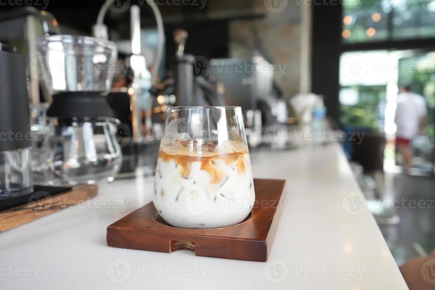 Ice coffee latte in coffee cafe. Fresh drink. photo