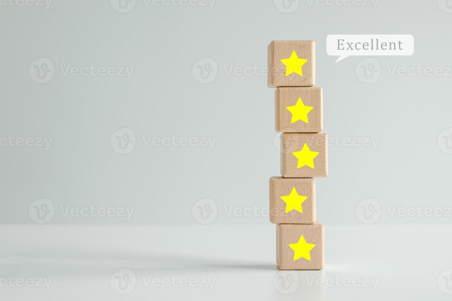 Evaluation, Satisfaction, Feedback, Review concept. Five star on stack of wooden block with Excellent on speech bubble. The best excellent business services rating customer experience. photo