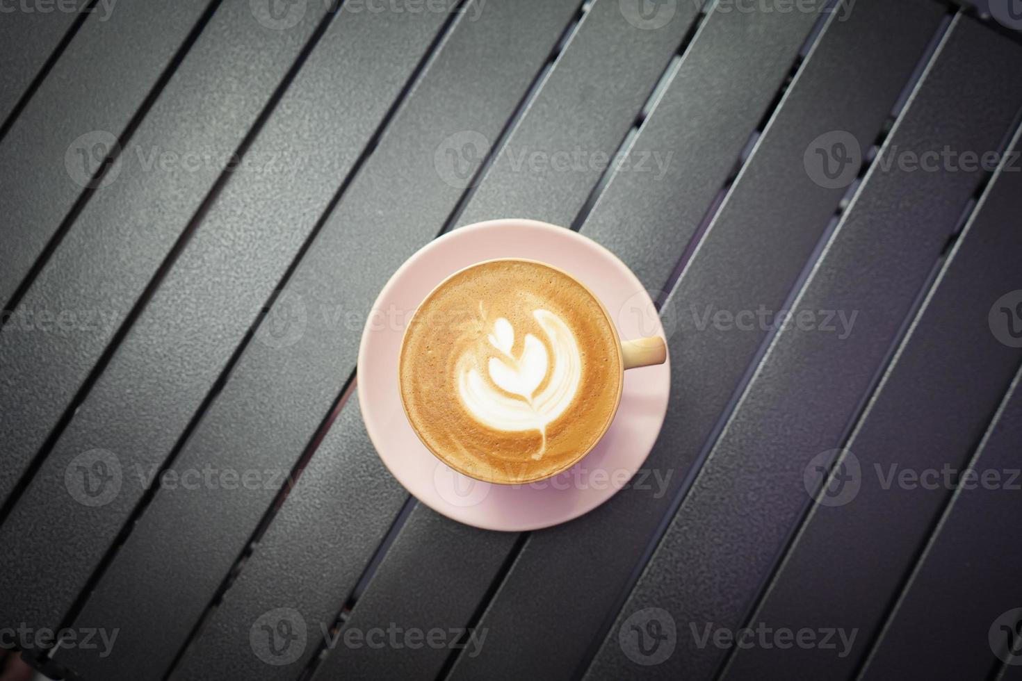 Top view of Coffee cup with latte art on table in coffee cafe. Morning coffee. photo