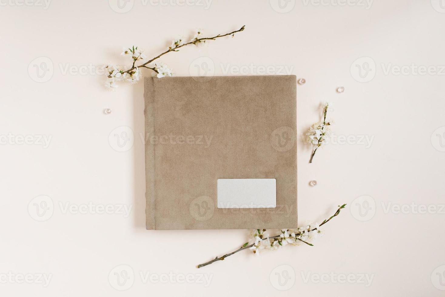 Beige family or wedding photo album with apple flowers