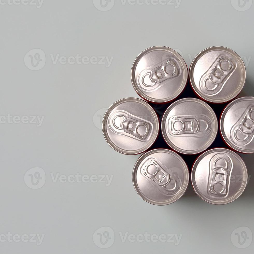 Many new aluminium cans of soda soft drink or energy drink containers. Drinks manufacturing concept and mass production photo