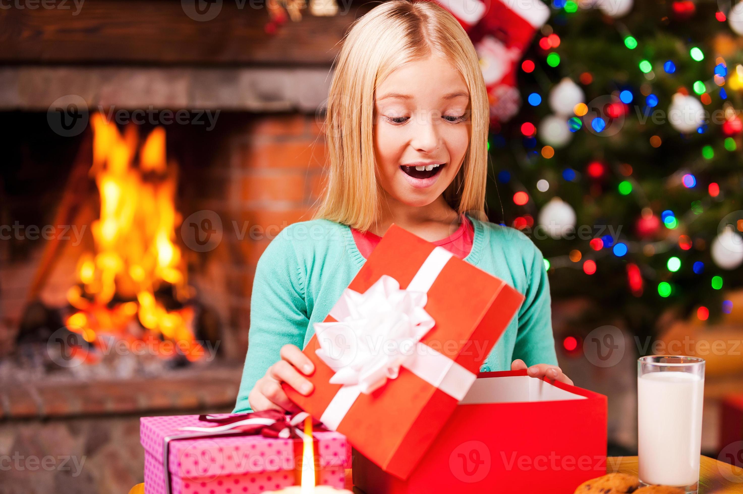 Girl opening christmas presents 2025
