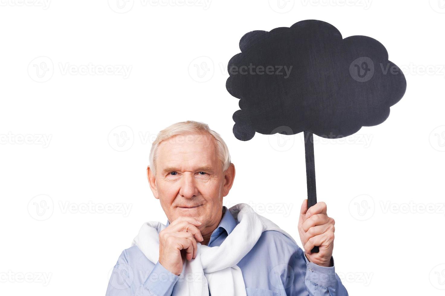 Lost in thoughts. Portrait of thoughtful senior man holding hand on chin and copy space while standing against white background photo