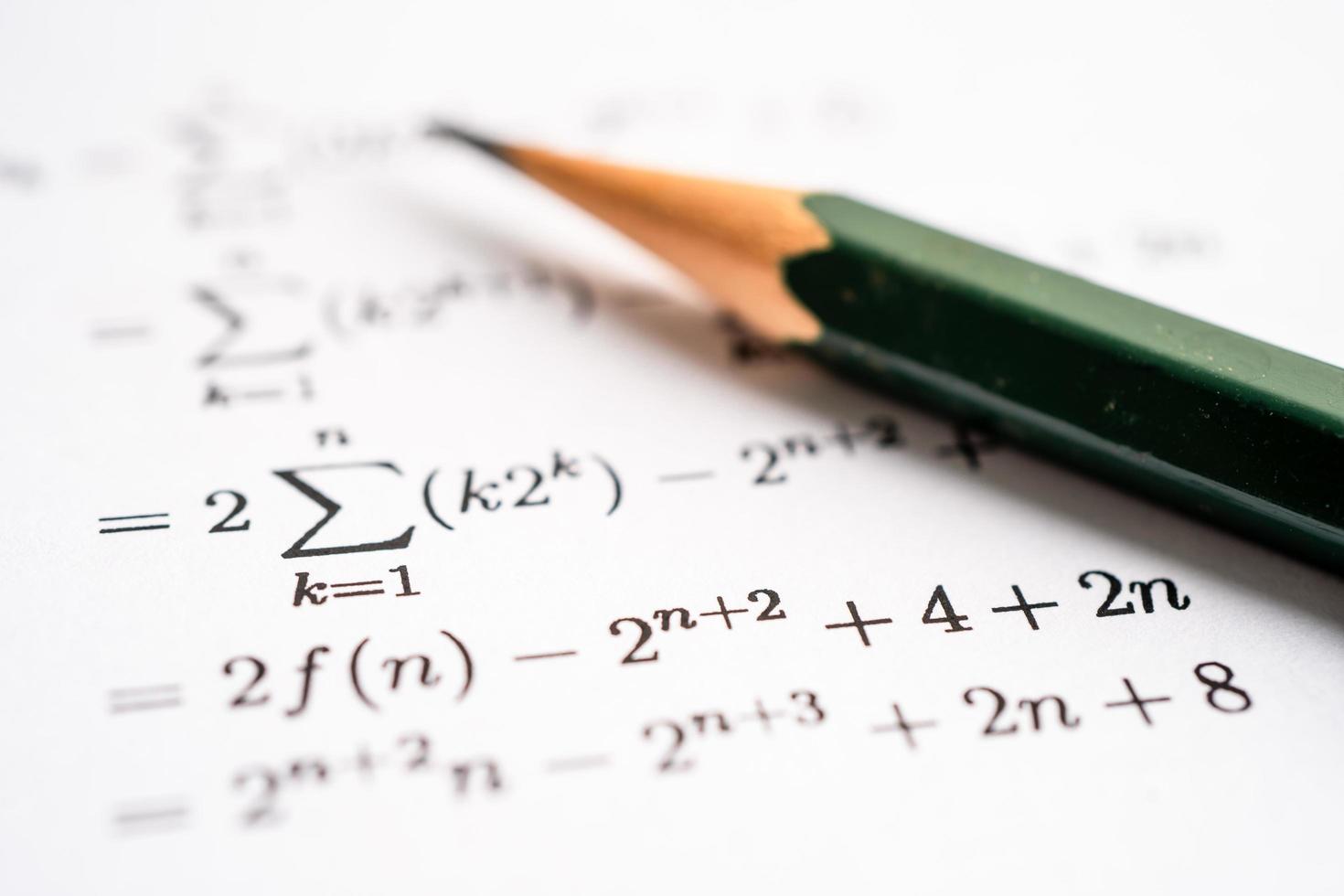 Pencil on mathematic formula exercise test paper in education school. photo