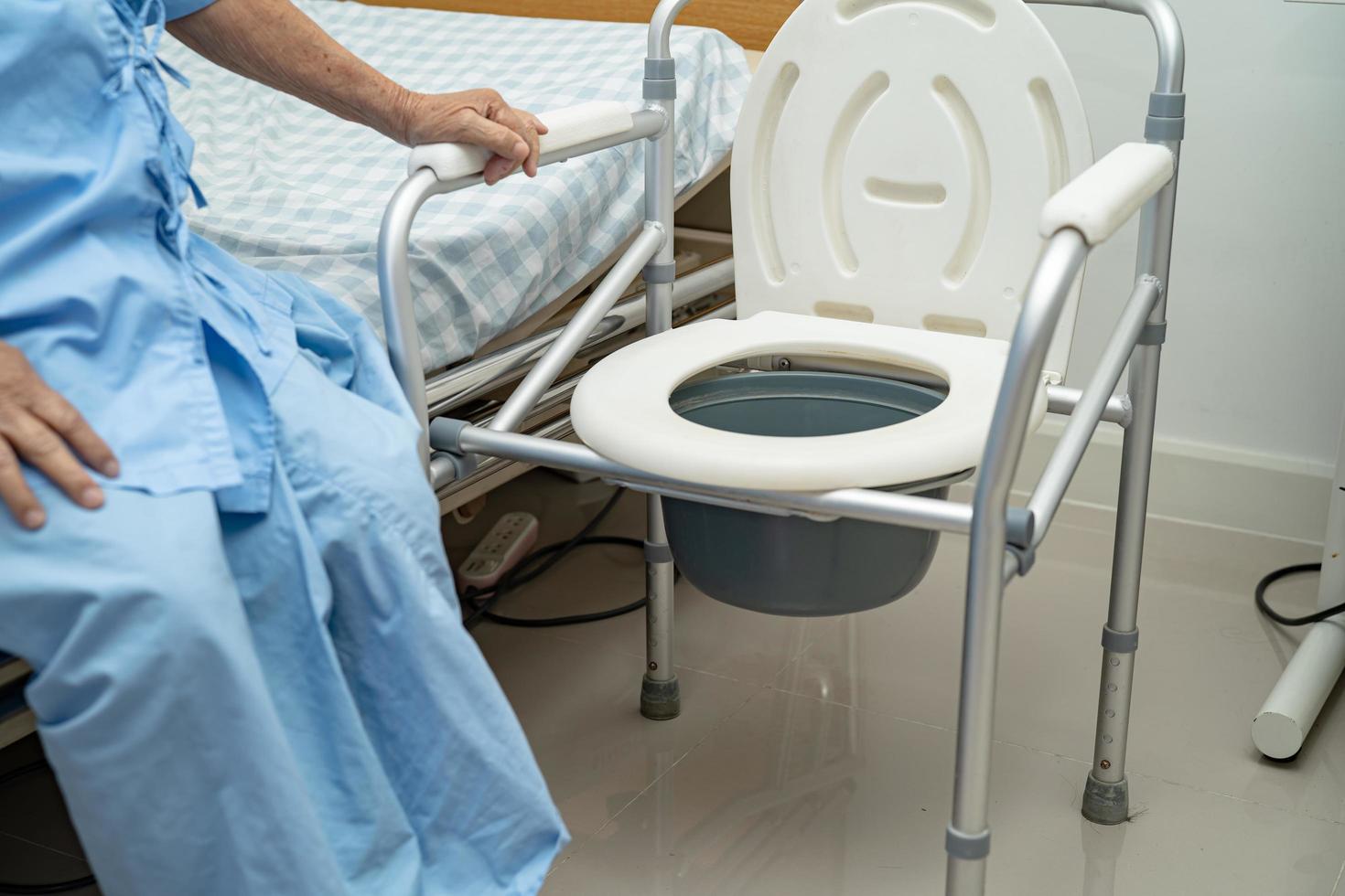 Flush toilet and shower chair in bathroom for old elder people. photo