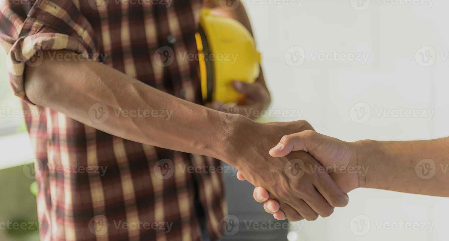 Businessmen join hands to invest and share profits in real estate projects. photo