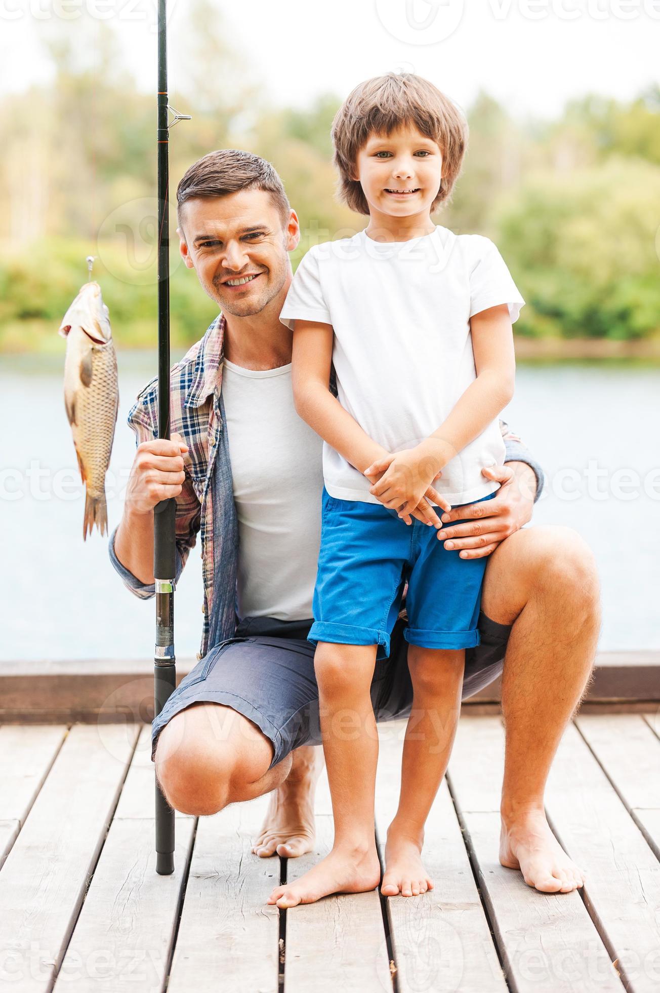 Look what we caught. Father and son looking at camera and smiling