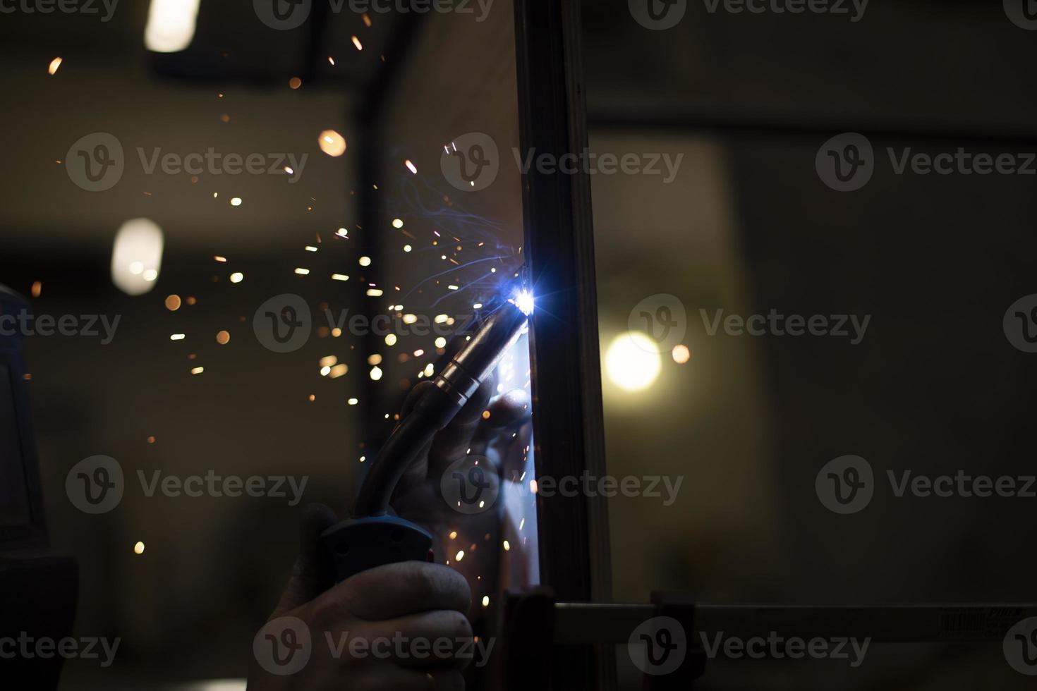 Welding work. Sparks from welding metal. Production details. photo