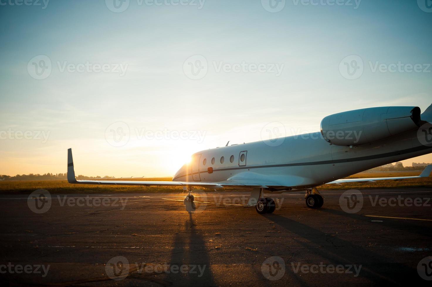 Taking off. Airplane taking off from airport with sunrise in the background photo