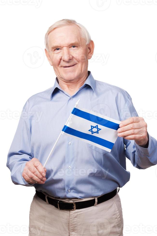 Israeli senior man. Cheerful senior man holding flag of Israel and smiling at camera while standing against white background photo