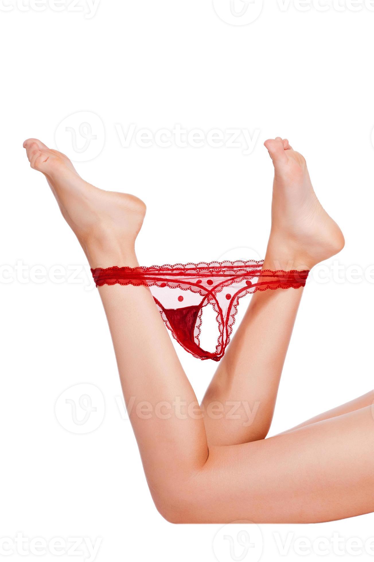 Without hesitating. Close-up of young woman taking off her panties while  lying against white background 13293197 Stock Photo at Vecteezy