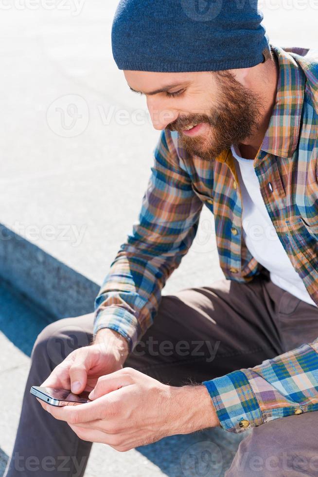 Lovely message for completing the day . Handsome young man sitting and writing a message photo