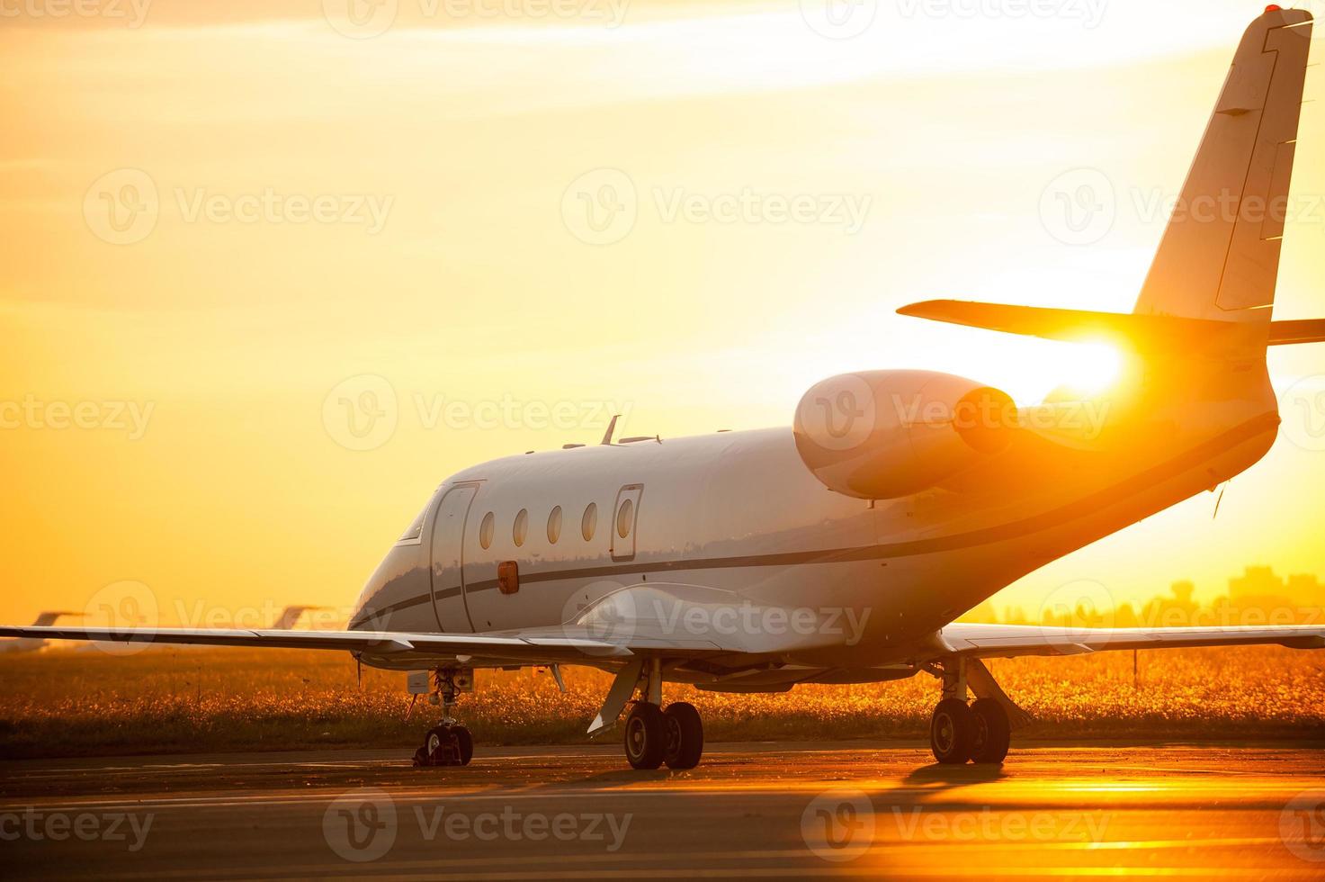 Taking off. Airplane is taking off from airport with sunset in the background photo