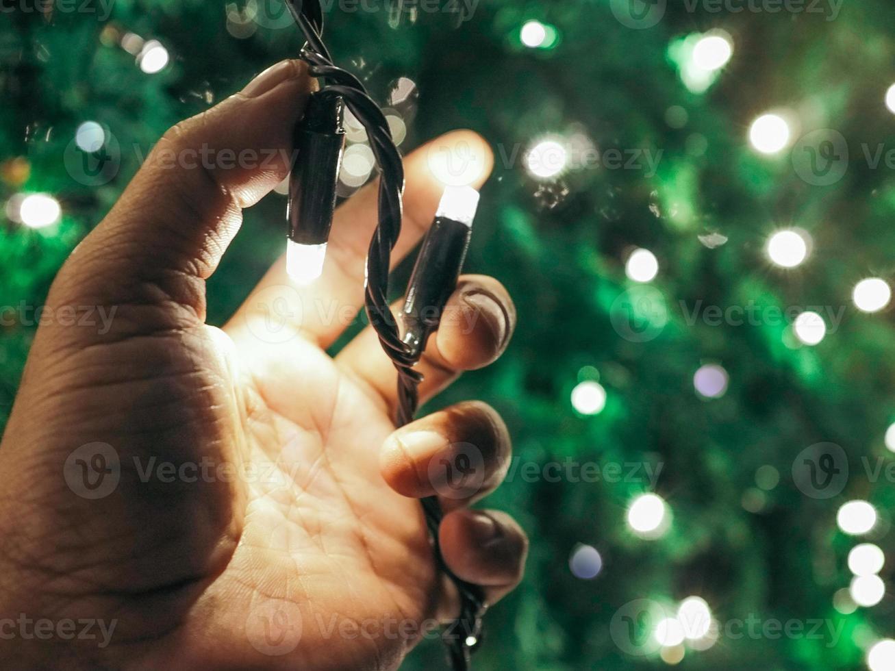 Hand holding the festive lights photo
