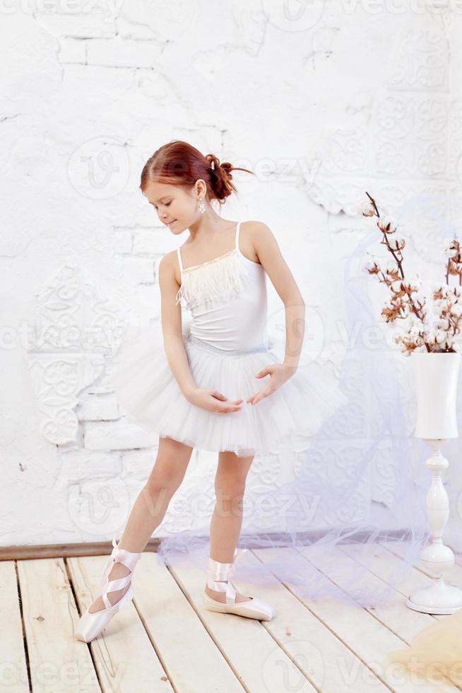 Young ballerina girl is preparing for a ballet performance. Little prima ballet photo