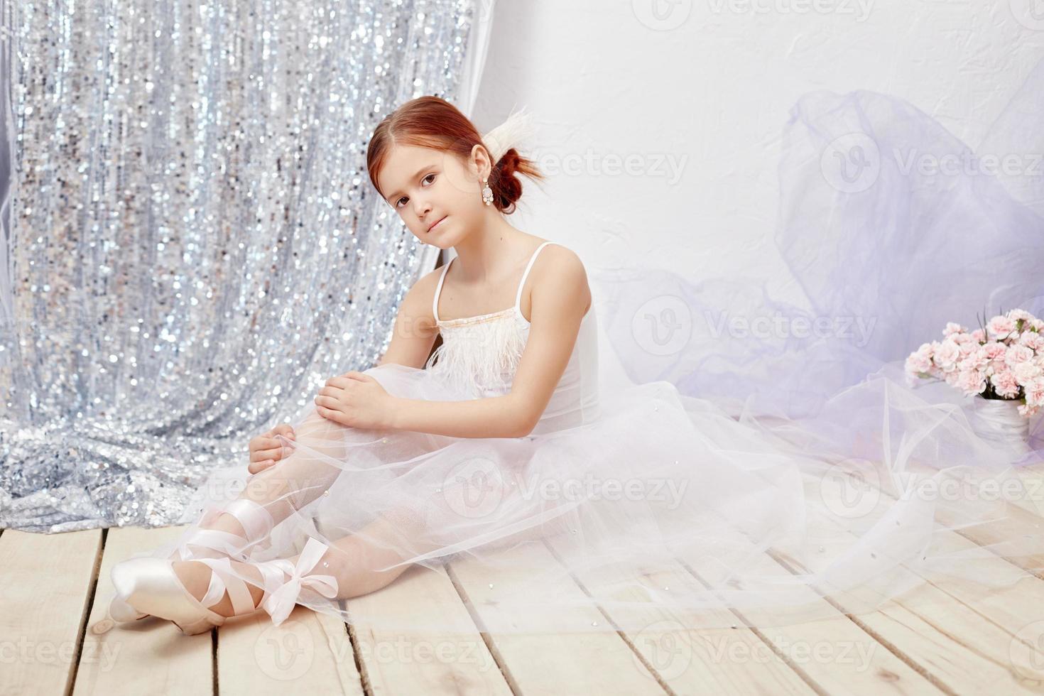 Little prima ballet. Young ballerina girl is preparing for a ballet performance photo