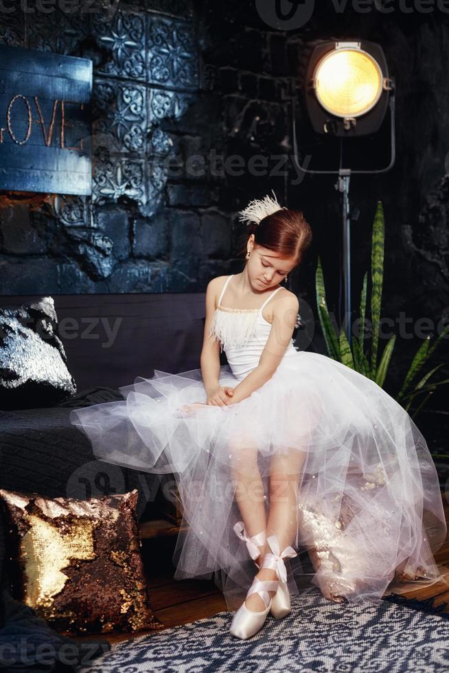 Girl in a white ball gown and shoes, beautiful red hair. Young theater actress photo
